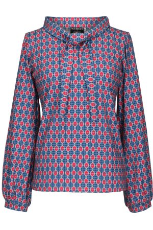 Margot Bluse Royalty Blusen har et feminint, retroinspireret design med fine detaljer og et elegant mønster. Den let figursyede pasform sidder flot uden at stramme og kan styles både løst eller stukket ned i en nederdel eller et par bukser.  Den høje ståkrave giver et sofistikeret udtryk, og foran er blusen afsluttet med et bindebånd, der kan bindes til en sløjfe eller bæres løst for et mere afslappet look.  De lange ærmer med let volumen og blød rynkning ved håndleddene understøtter blusens klassiske og elegante udtryk.  Små grafiske motiver i rød og pink på en blå, ternet baggrund skaber et tydeligt vintagepræg samt et livligt, men harmonisk udtryk.  Kombinationen af blå nuancer med pink og rød giver blusen et friskt og feminint look med masser af personlighed.   Blusen er alsidig og kan bruges både til hverdag og ved mere festlige lejligheder. Den passer godt til: Mørkeblå jeans for et afslappet, men stilfuldt hverdagslook. Marineblå, røde eller bordeaux bukser for et farvekoordineret outfit. En ensfarvet nederdel i blå eller pink nuancer for et mere elegant udtryk. En blazer eller cardigan i marineblå, grå eller bordeaux på kølige dage.